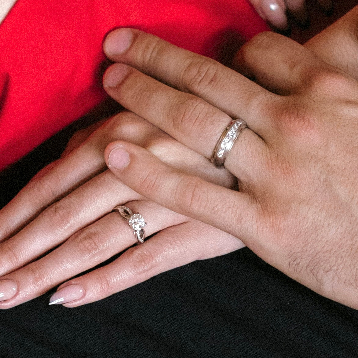 Men and Women's Engagement rings on hands of male and female model