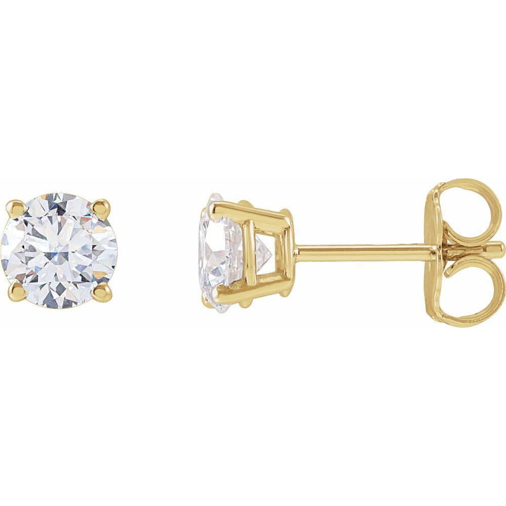 Pair of diamond stud earrings on a light gray fabric background