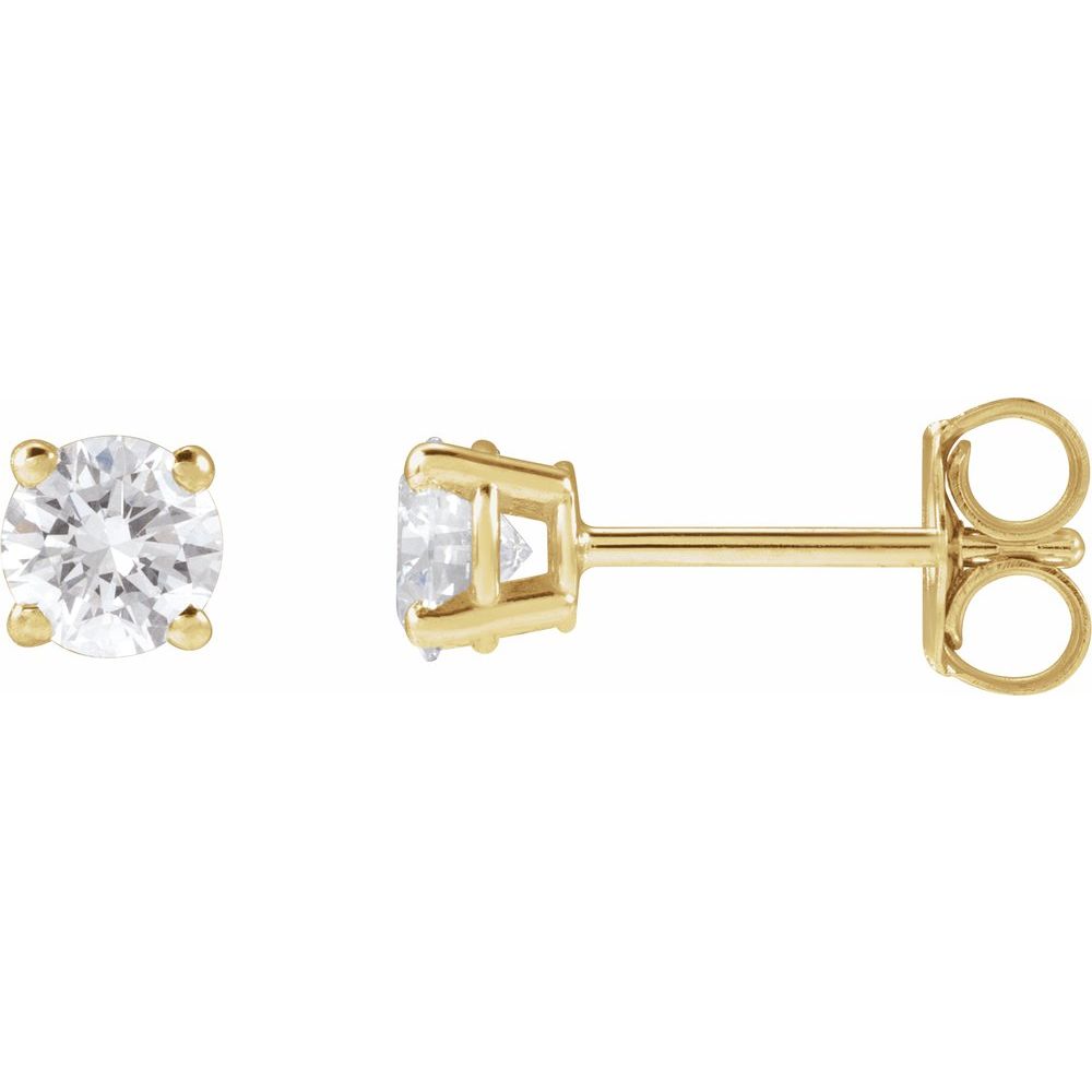 Pair of diamond stud earrings on a light gray fabric background