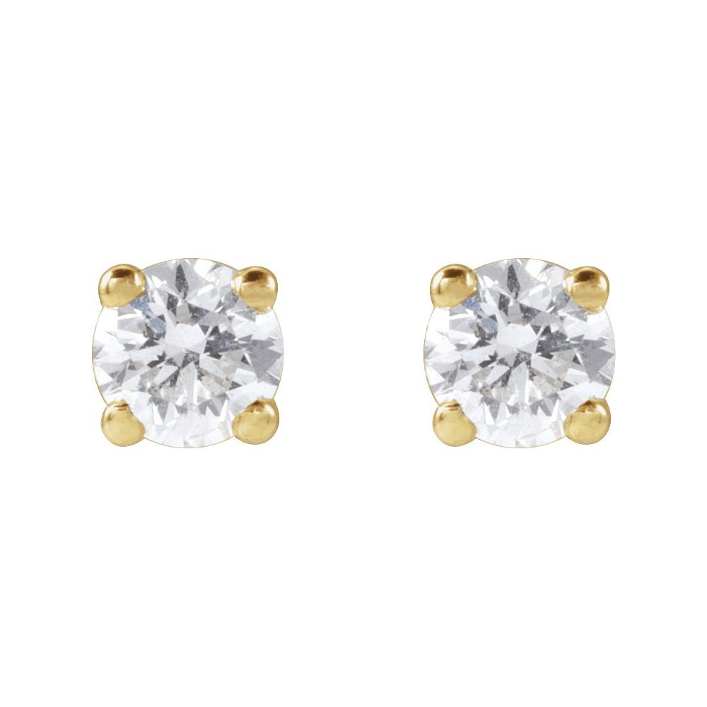 Pair of diamond stud earrings on a light gray fabric background