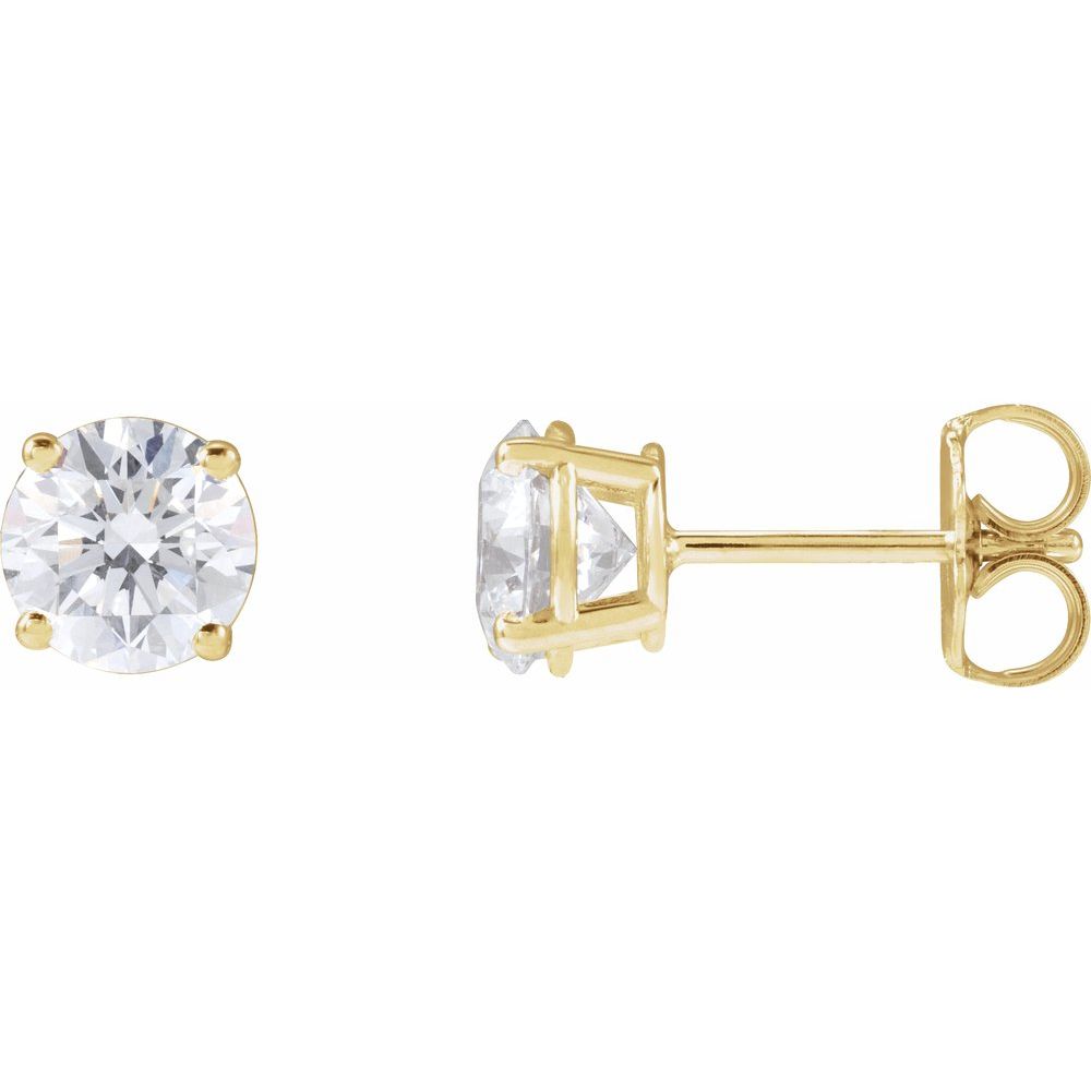 Pair of diamond stud earrings on a light gray fabric background