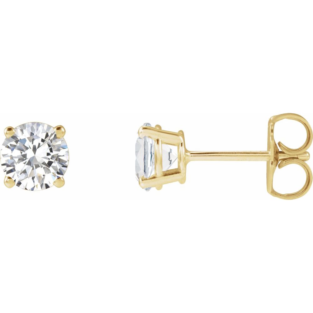 Pair of diamond stud earrings on a light gray fabric background