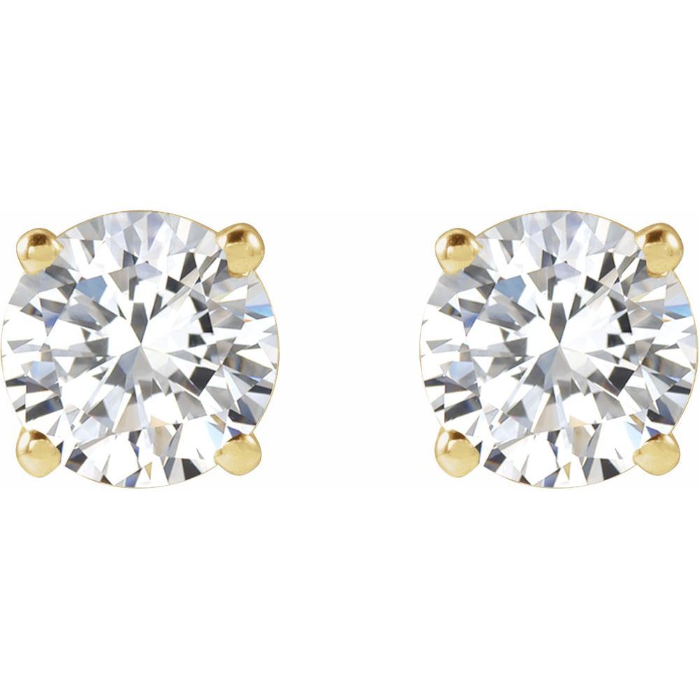 Pair of diamond stud earrings on a light gray fabric background