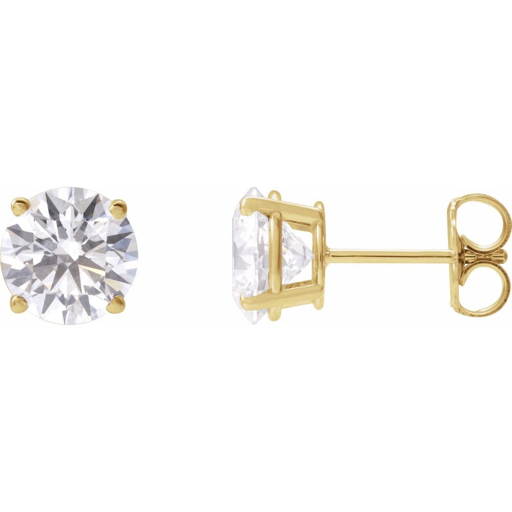Pair of diamond stud earrings on a light gray fabric background