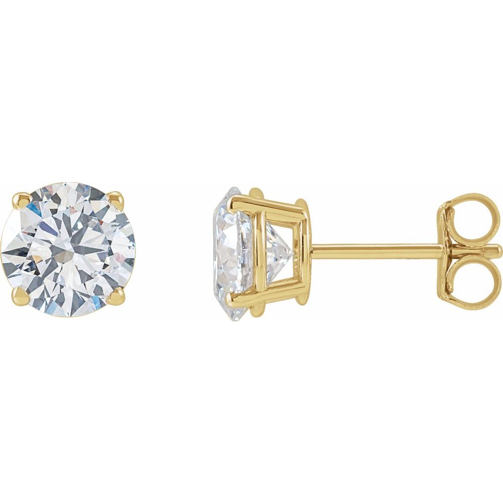 Pair of diamond stud earrings on a light gray fabric background