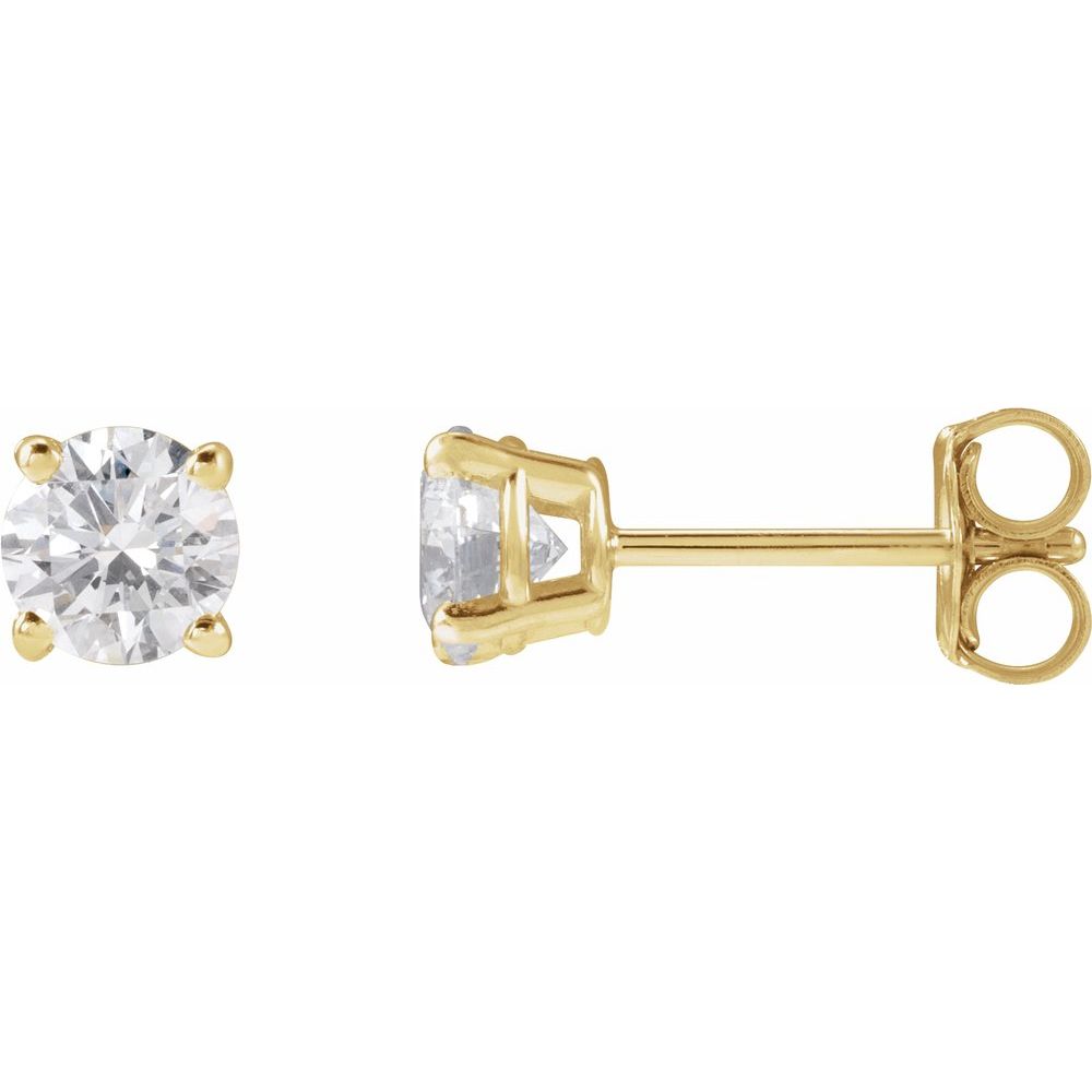 Pair of diamond stud earrings on a light gray fabric background