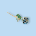Blue rose-shaped hairpin with gold accents on a light blue background