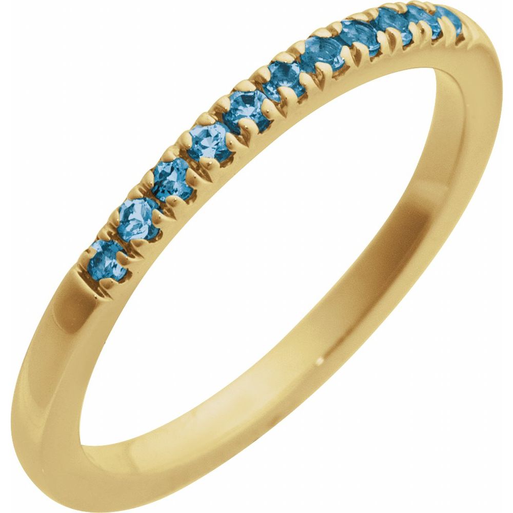 Gold ring with blue gemstones on a light gray background, labeled 'December Blue Topaz'.