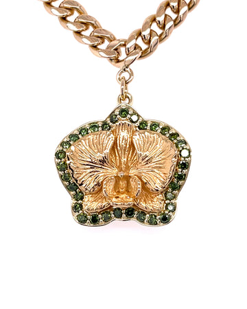 Green Diamond accented around flower pendant in yellow gold