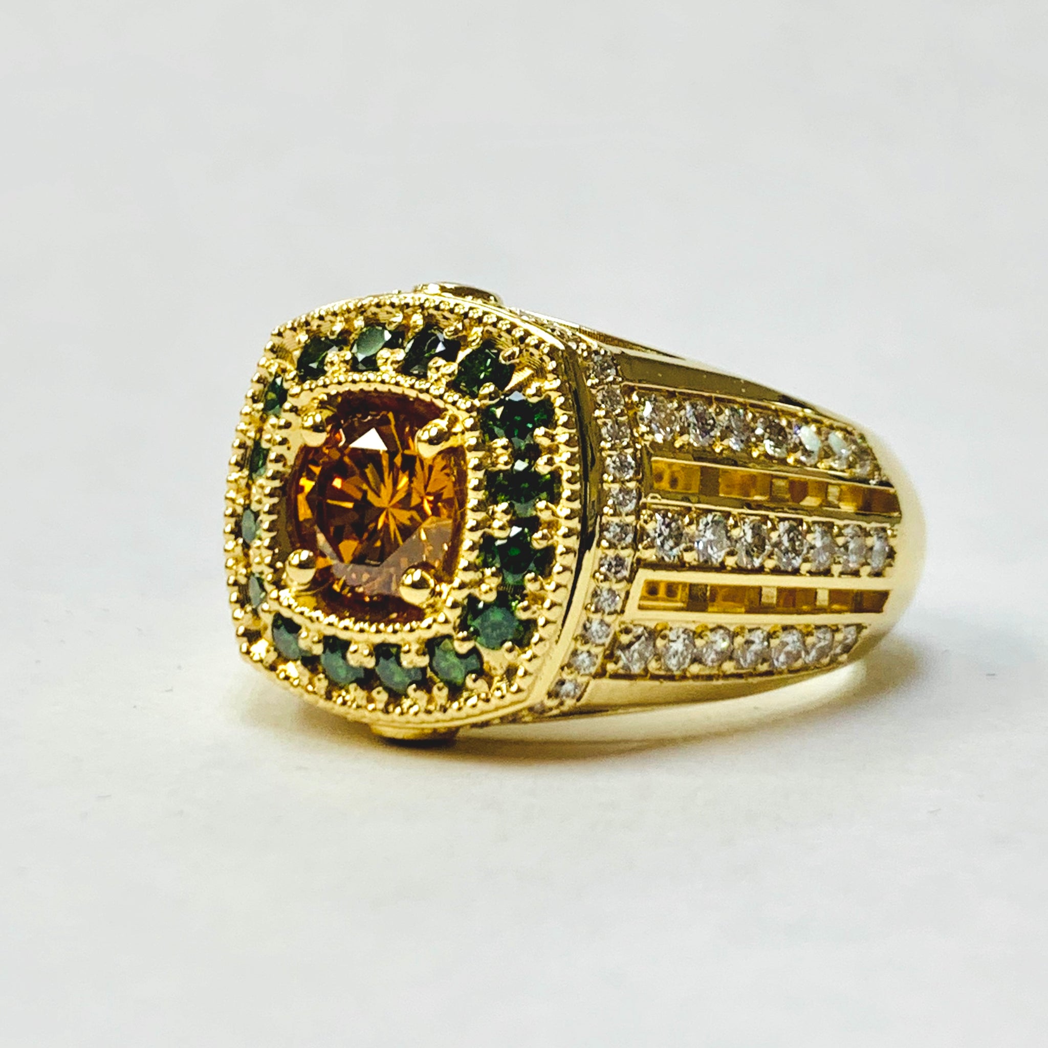 Gold ring with gemstones on a white background