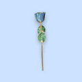 Decorative hair stick with blue and green leaves on a light blue background