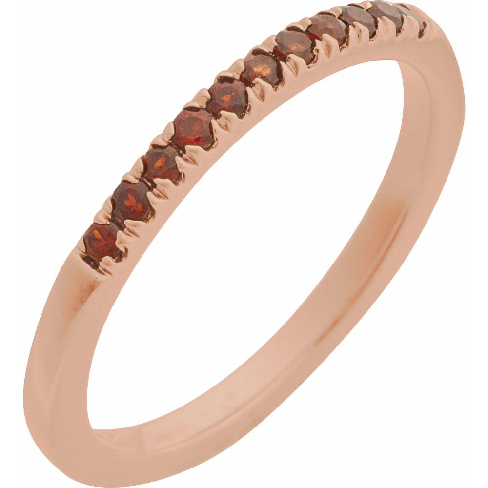 Rose gold ring with embedded brown gemstones on a white background