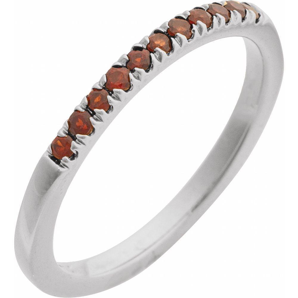 Silver ring with small brown gemstones on a white background