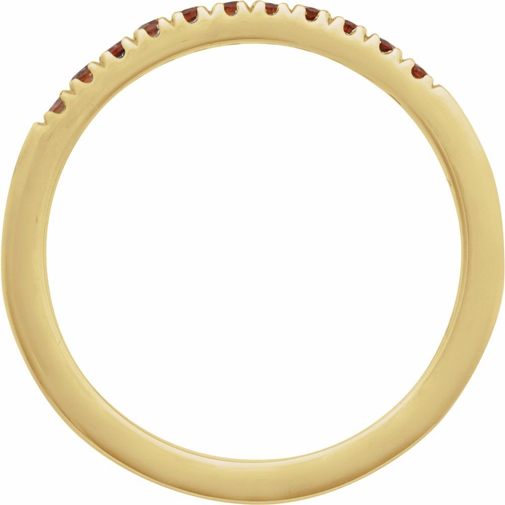 Gold ring with embedded red stones on a white background