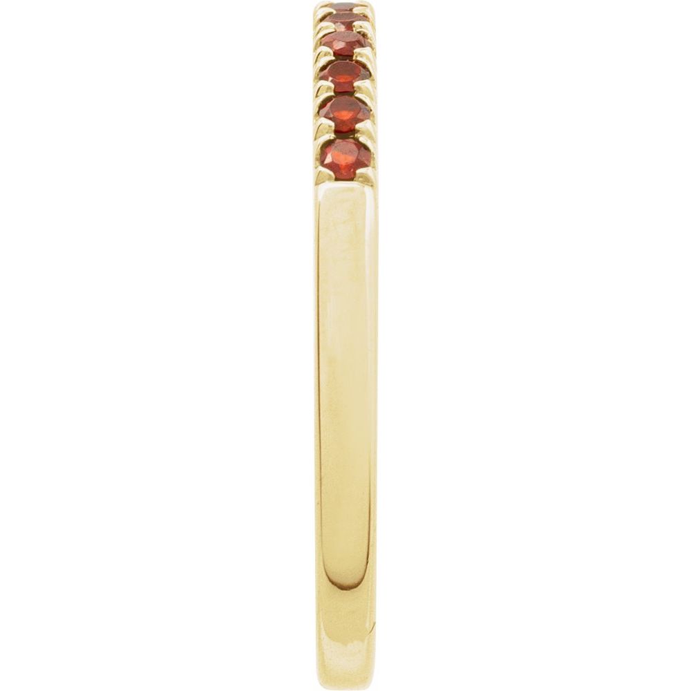 Gold ring with red gemstones on a white background