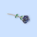 Blue rose-shaped brooch on a light blue background